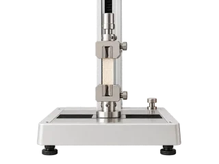 Illustrative textile testing apparatus holding a narrow fabric sample.