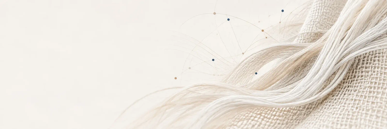 Editorial composition of pale textile fibers opening into threads and woven fabric, with fine connecting lines.
